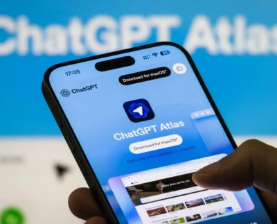 OpenAI Atlas browser interface on laptop screen with warning alert symbol representing prompt injection vulnerability and AI security threats.
