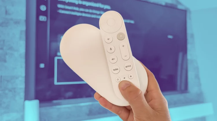 Chromecast with Google TV 4K streaming device connected to flat-screen TV showing Google TV interface and discounted sale banner.