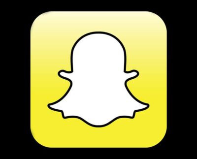Snapchat logo on smartphone screen with paid subscription concept User browsing Snapchat stories with storage notification alert Snapchat subscription plan illustration for saving old posts Young people using Snapchat app with digital cloud storage icon Snapchat premium features for saving memories and old snaps