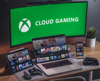 Xbox Cloud Gaming interface showcasing free ad-supported tier on multiple devices. Concept showing Xbox Cloud Gaming ads appearing before gameplay session. Gamer streaming Xbox titles on smartphone via free Cloud Gaming service.