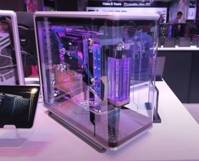 Cooler Master MasterFrame 400 Mesh compact modular PC case on display. Close-up of the MasterFrame 400 Mesh showing full mesh front panel for airflow. PC builder assembling components inside the Cooler Master MasterFrame 400 Mesh. Side view highlighting the exo-structure and tempered glass panels of MasterFrame 400 Mesh. Cooling fans and radiator setup inside the Cooler Master MasterFrame 400 Mesh. Comparison between MasterFrame 400 Mesh and larger MasterFrame series models. Cooler Master showcasing the new MasterFrame 400 Mesh at a tech expo.