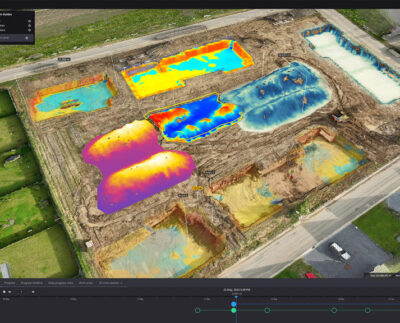 Digital twin simulation of an excavator in a construction site. Engineer analyzing real-time data from earthmoving machinery on a tablet. 3D model of a bulldozer used for predictive maintenance planning. Virtual simulation showing optimized excavation routes for heavy equipment. Construction manager using digital twin software to improve job site safety. IoT sensors collecting data from dump trucks for real-time performance monitoring. Visualization of sustainable earthmoving practices using digital twin technology.