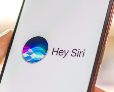 Concept image of iOS 27 interface showcasing Siri and Apple Intelligence AI upgrades. Illustration of Apple’s new Health+ app analyzing personal wellness data. iPhone screen displaying redesigned Siri with AI-powered suggestions. Apple Intelligence logo representing next-generation AI technology in iOS 27. User tracking daily fitness and sleep metrics on iPhone Health app. Comparison of iOS 27 Siri improvements versus previous iOS versions. Apple executive presenting iOS 27 features and AI innovations on stage.